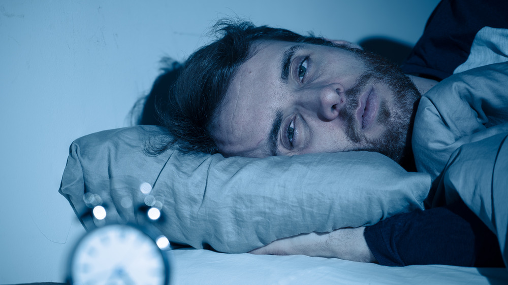 Man lying awake in bed