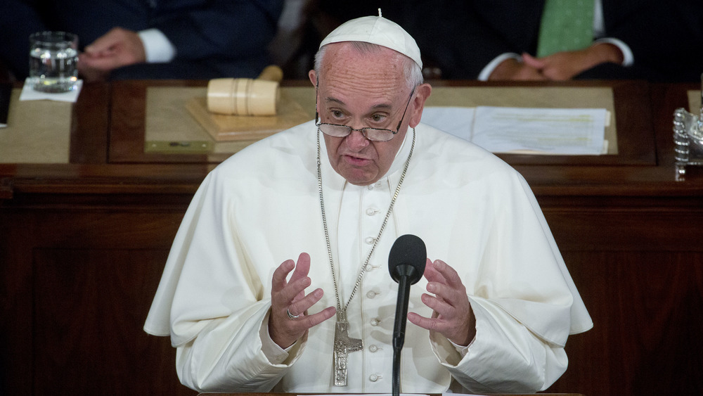 Pope Francis speaks at podium