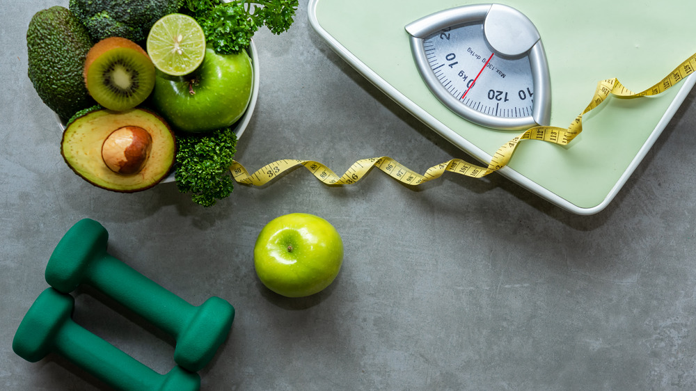 Wellness: vegetables, weights, a scale