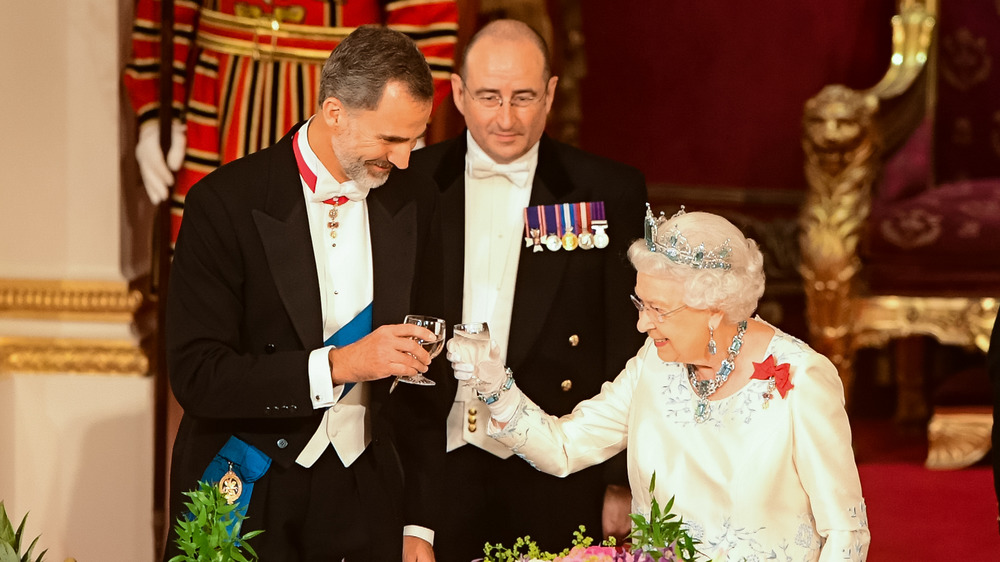 Britain's Queen Elizabeth II, and King Felipe VI of Spain share a toast at the State Banquet at Buckingham Palace on July 12, 2017 in London, England. 