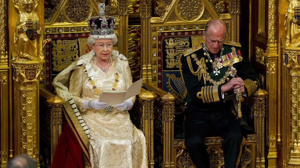 Prince Philip, Duke of Edinburgh (R), listens as his wife, Britain's Queen Elizabeth II speaks as she addresses the House of Lords during the State Opening of Parliament in the Palace of Westminster before the State Opening of Parliament on May 25, 2010 in London, England