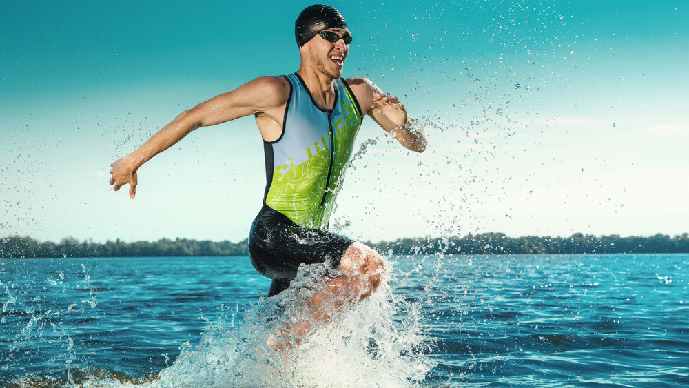 Triathlete running out of the water