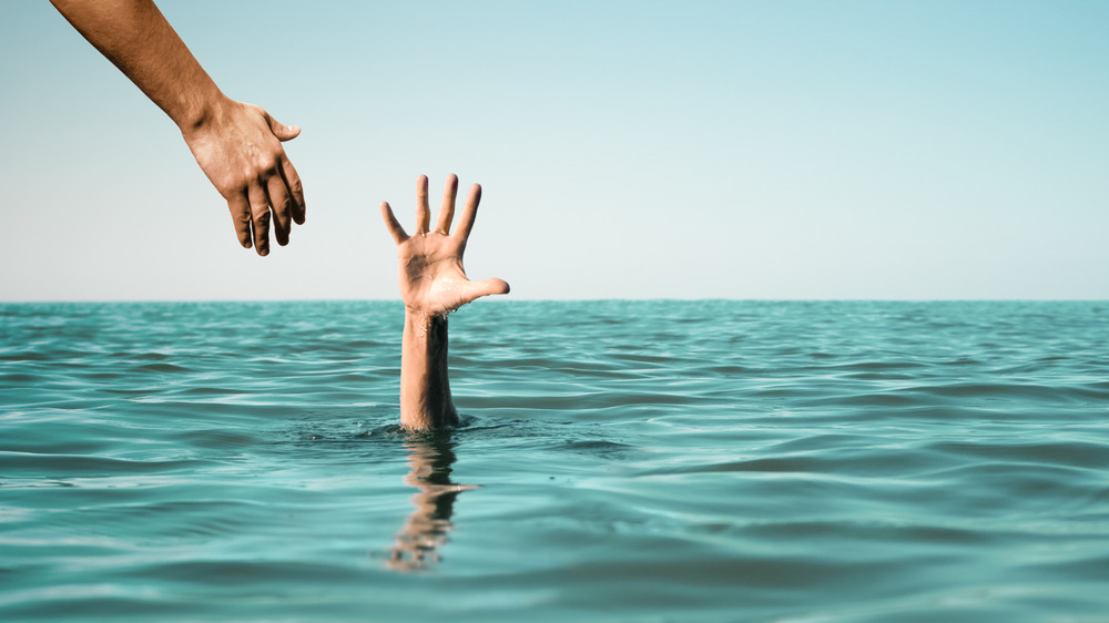 Hand extended to drowning person