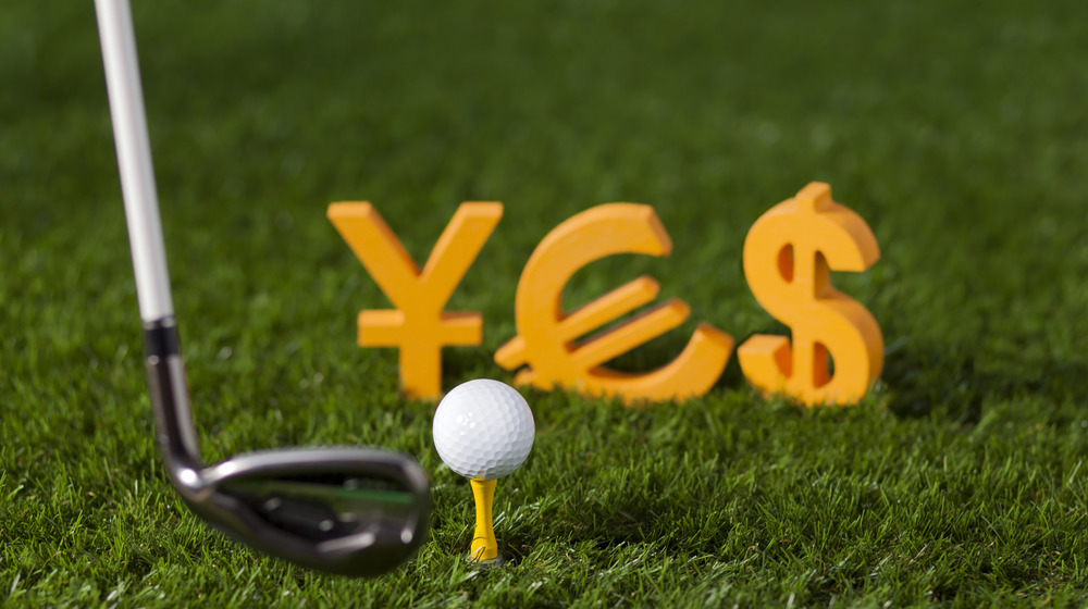 Golf club with money symbols