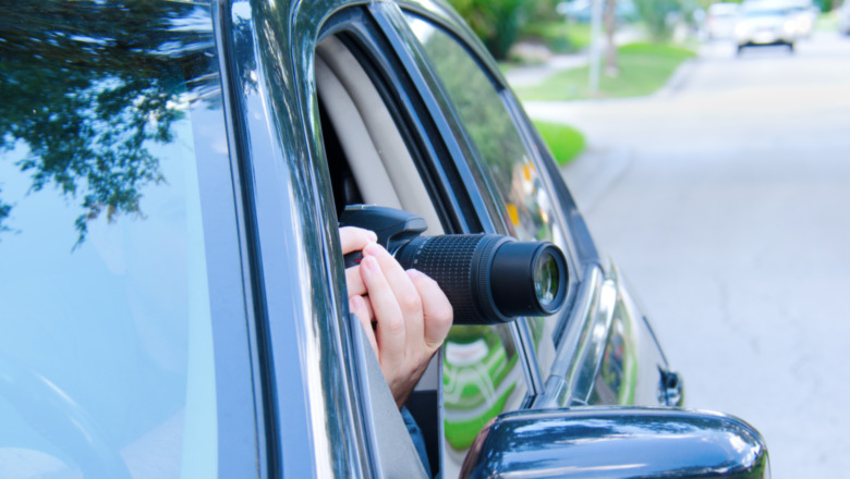 Photographer in a car taking pictures 