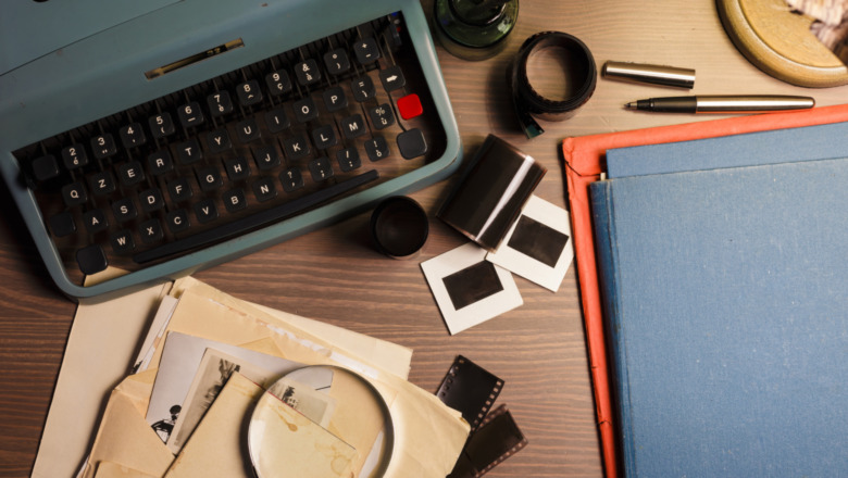 A table with files, a typewriter, and a magnifying glass