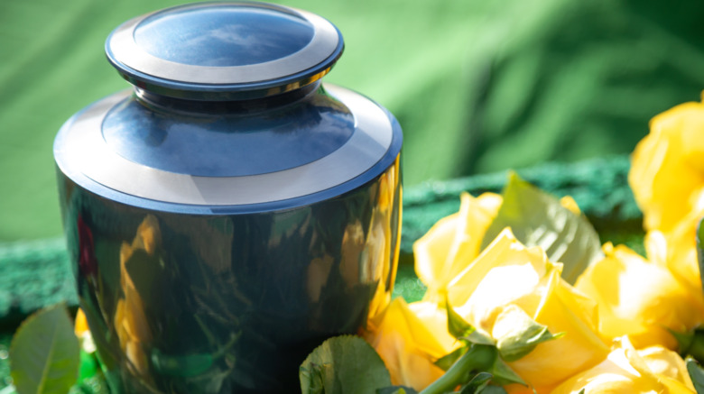 elegant cremation urn beside flowers