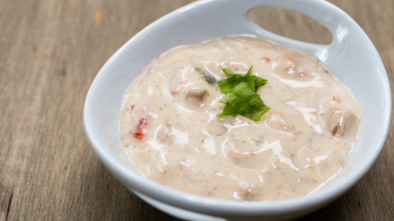 Close up of a white bowl of clam dip