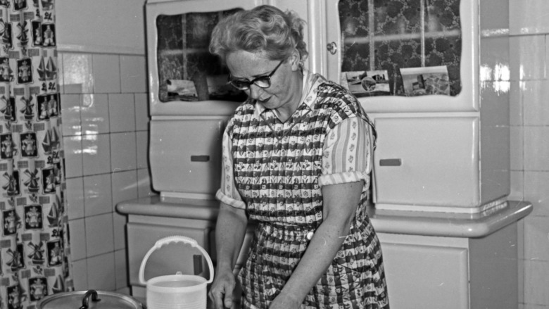 Older 1950s woman in kitchen