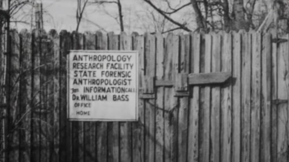 Bass body farm sign on wooden fence