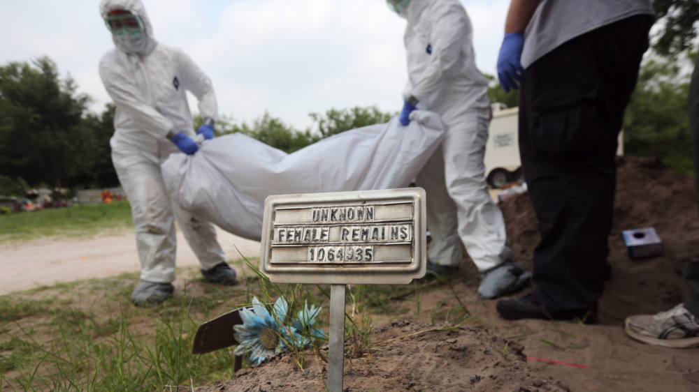 Forensic anthropology team carrying body