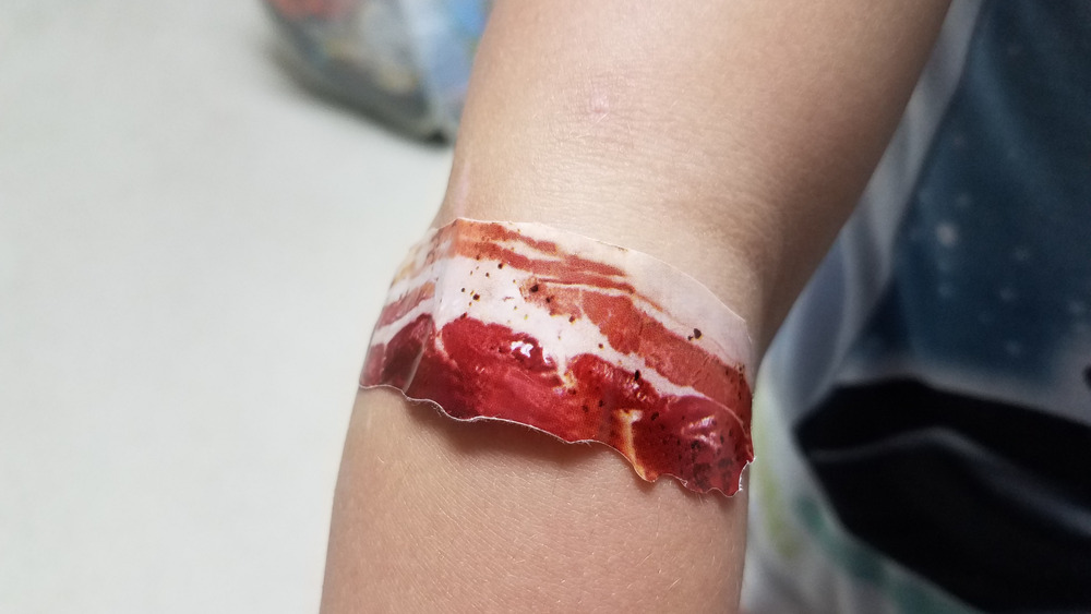 A bacon bandage on a child's arm