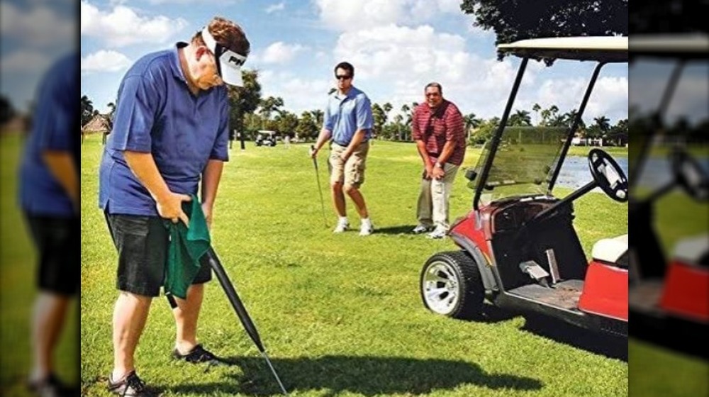 A man using a UroClub on the golf course