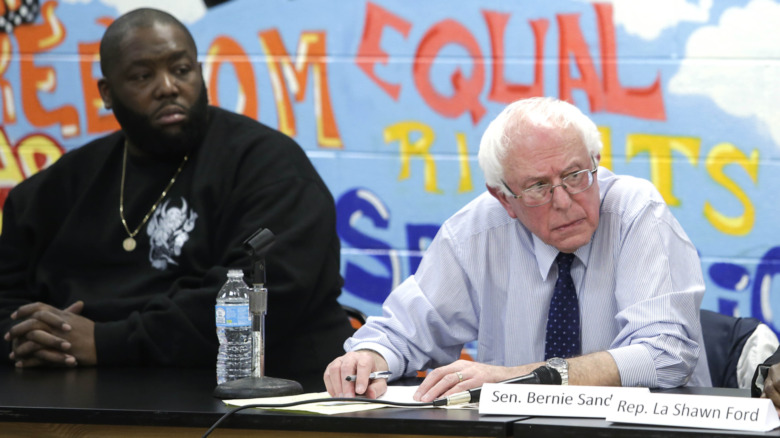Killer Mike and Bernie Sanders seated at panel