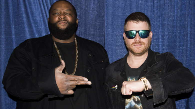 Run the Jewels posing with their hand sign
