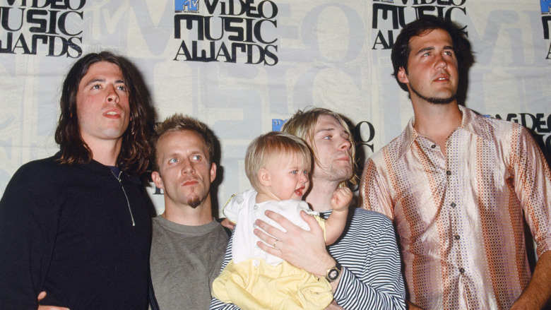 Kurt Cobain with the rest of Nirvana (and Frances Bean)