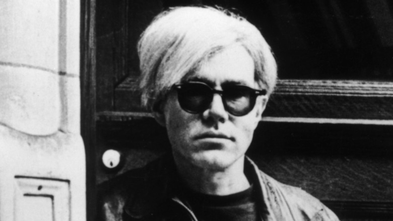 Andy Warhol standing inside a door
