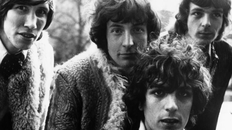 Pink Floyd close together smiling 