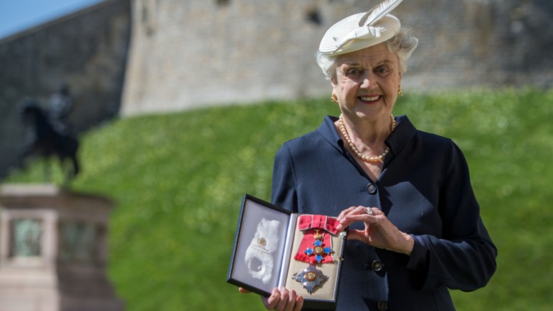Angela Lansbury smiling holding her medal 