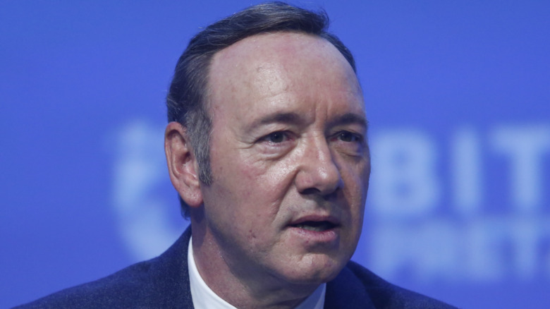 Kevin Spacey in front of a blue background