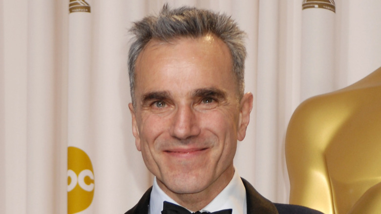 Daniel Day-Lewis in a suit smiling 