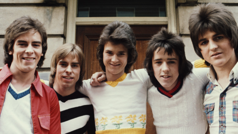 The Bay City Rollers with their arms around each other