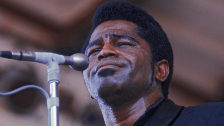 James Brown with eyes closed at mic