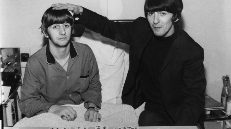Ringo Starr (left) gets a hospital visit from fellow Beatle George Harrison (right)