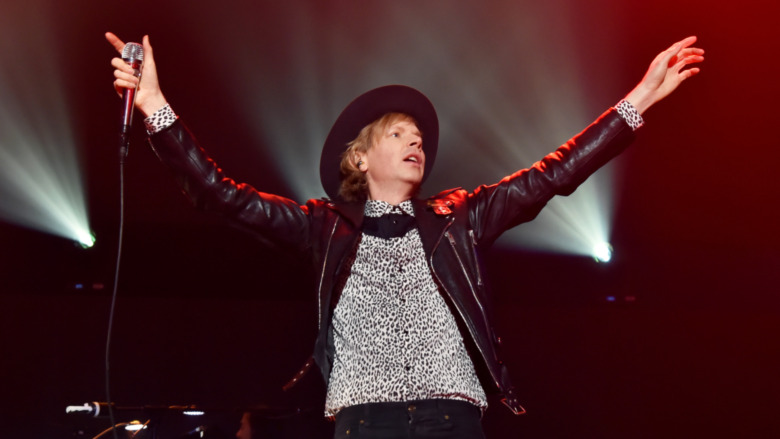 Beck on stage with microphone