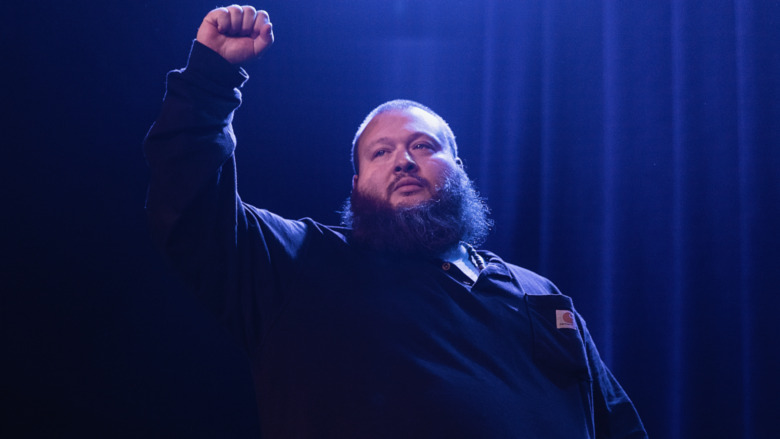 Action Bronson raising fist in the air