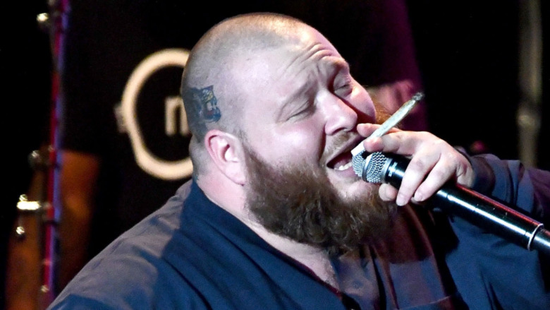 Action Bronson with mic and blunt in hand
