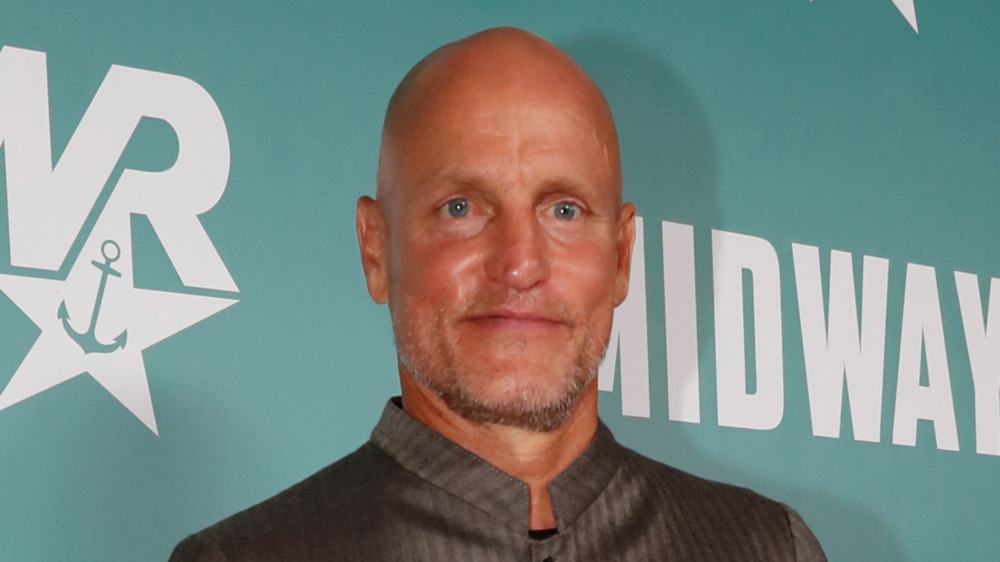 Woody Harrelson standing in button-down shirt