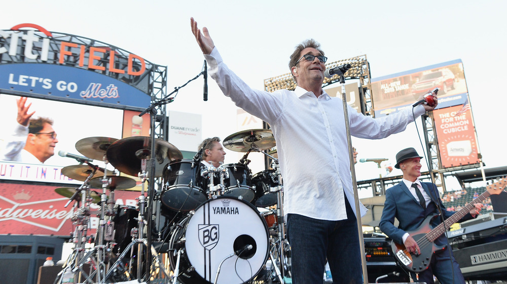 Huey Lewis with hands raised 