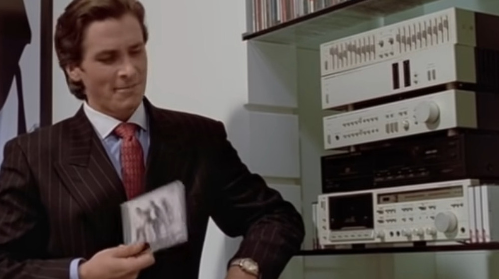 Christian Bale holding Huey Lewis and the News CD