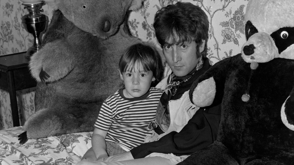 Julian Lennon sitting with John Lennon and teddy bears