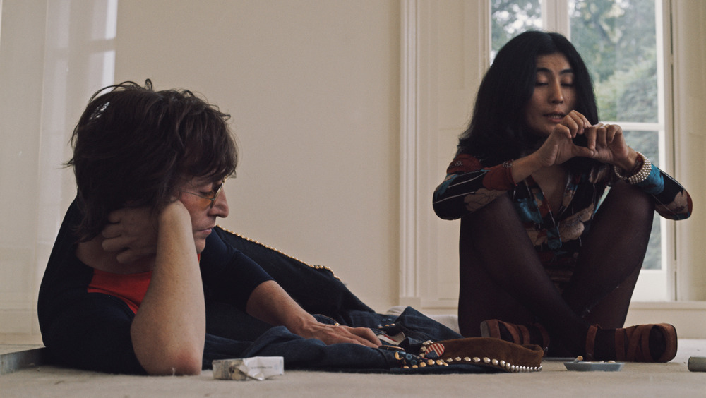 John Lennon sitting on floor with Yoko Ono