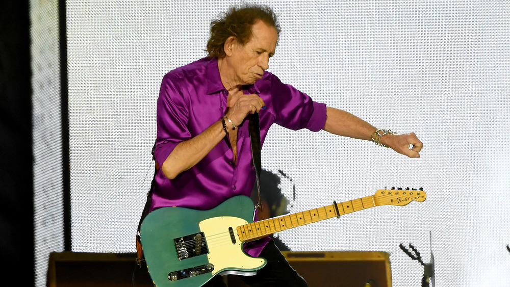 Keith Richards onstage playing guitar