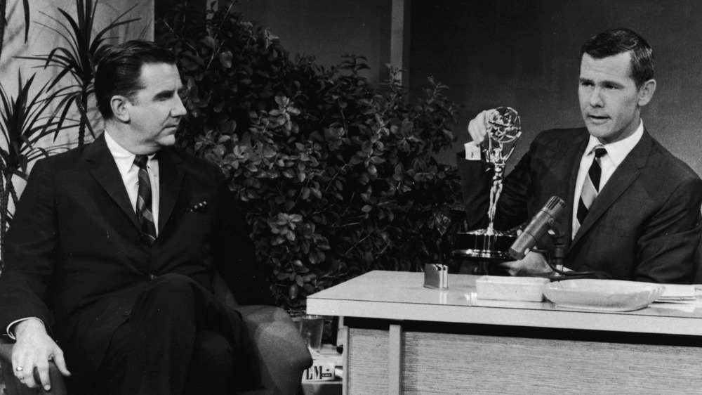 Johnny Carson sits at The Tonight Show desk 