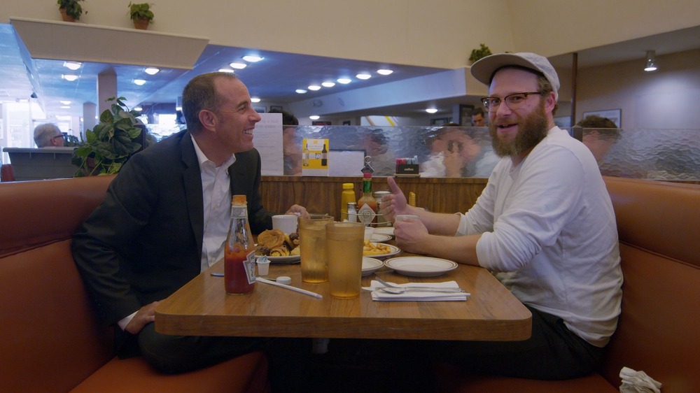 Jerry Seinfeld and Seth Rogen sitting at table