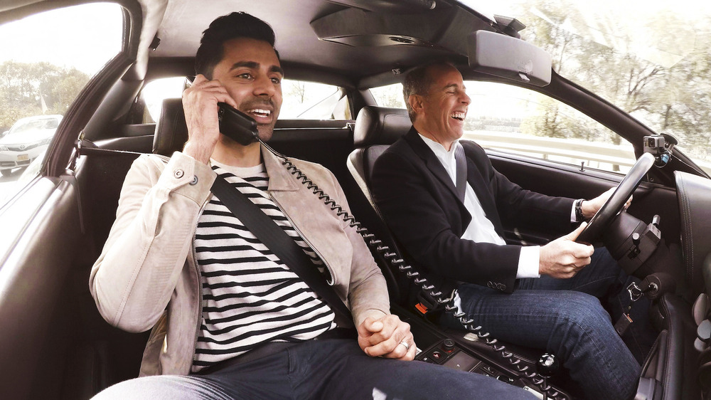 Hasan Minhaj on the car phone and Jerry Seinfeld laughing