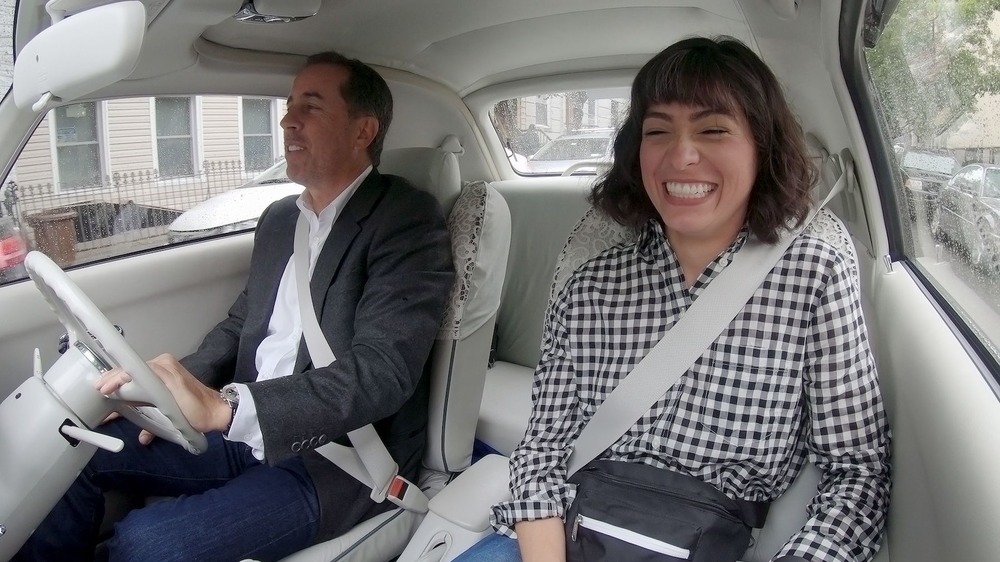 Jerry Seinfeld and Melissa Villaseñor laughing in car