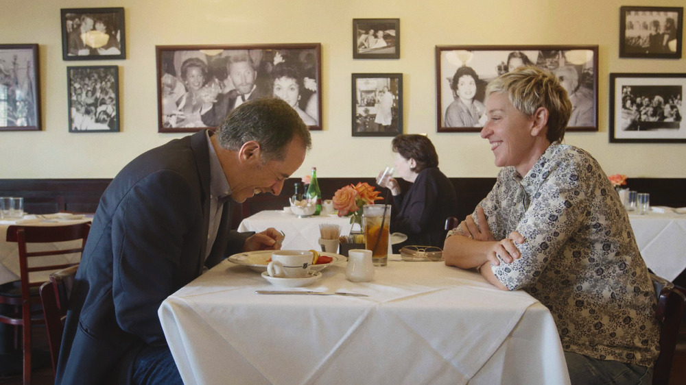 Jerry Seinfeld and Ellen DeGeneres laughing at table