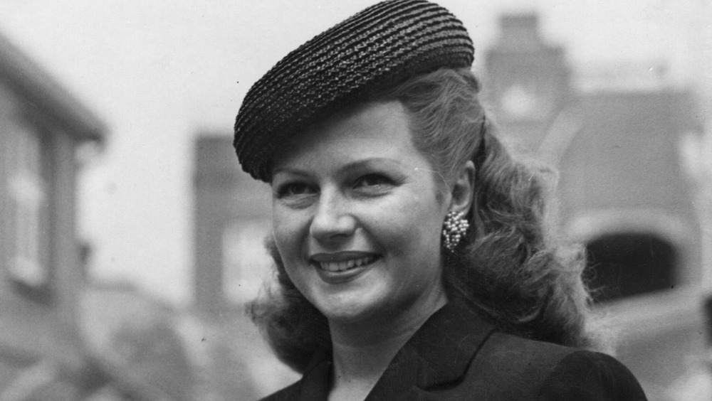 Rita Hayworth wearing hat and smiling 