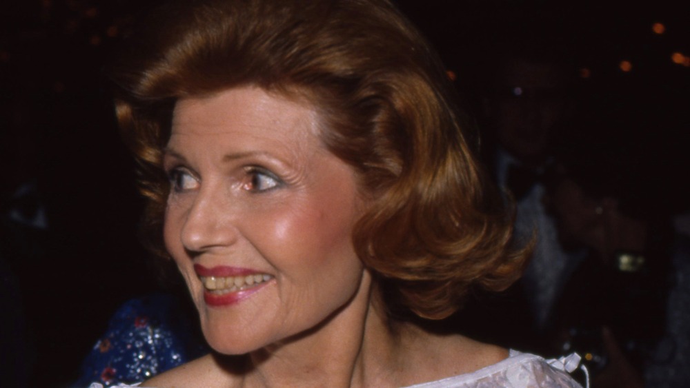 older Rita Hayworth smiling, looking to the side