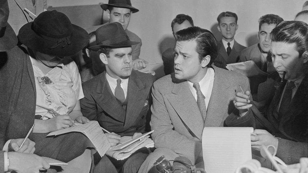 Photo of Orson Welles meeting with reporters in an effort to explain that no one connected with the War of the Worlds radio broadcast had any idea the show would cause panic.