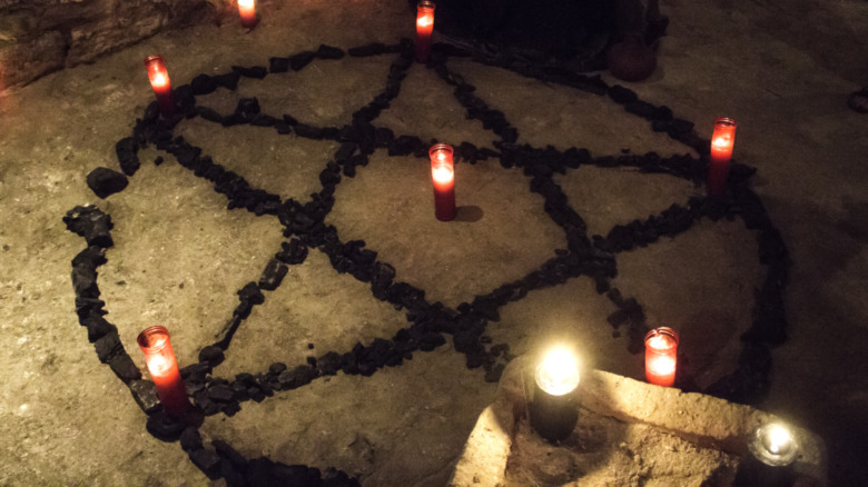 Pentacle symbol surrounded by candles