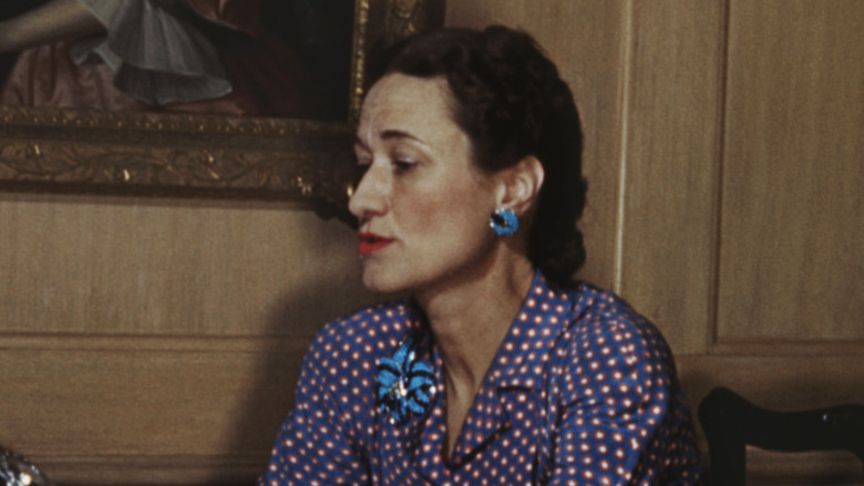 Wallis Simpson looking down at table