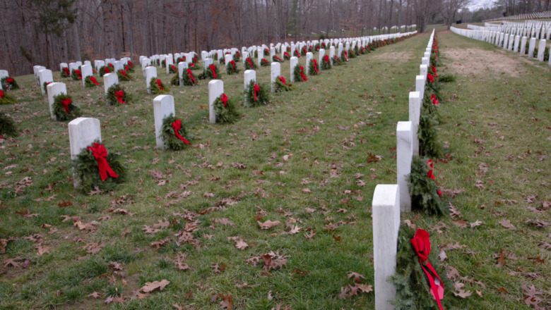 Wreaths placed on rows of white tombstones 
