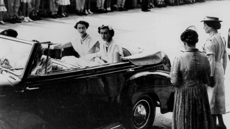 Queen Elizabeth accompanied by her lady-in-waiting