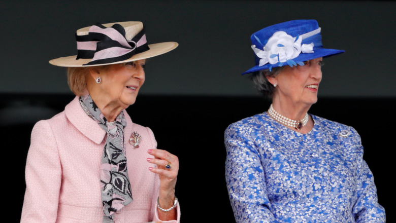 Two ladies-in-waiting smiling